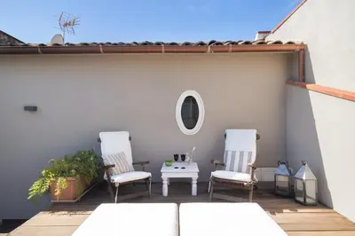 two chairs and a table on a patio at La Cala Terrace by Domusicily in Palermo