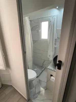 a bathroom with a toilet and a window at RC SUITE TERMINI IMERESE in Termini Imerese