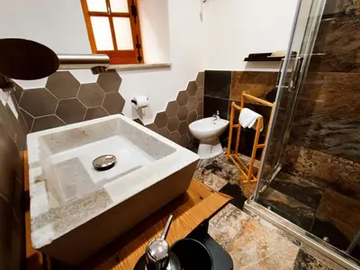 a bathroom with a sink and a toilet at Sicula Liz & Lulù in Palermo