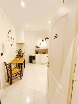 a kitchen and dining room with a table and a door at Sicula Liz & Lulù in Palermo