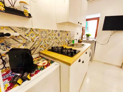 a kitchen with a stove and a sink at Sicula Liz & Lulù in Palermo