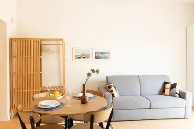 a living room with a table and a couch at Piricù Apartments in Castellammare del Golfo
