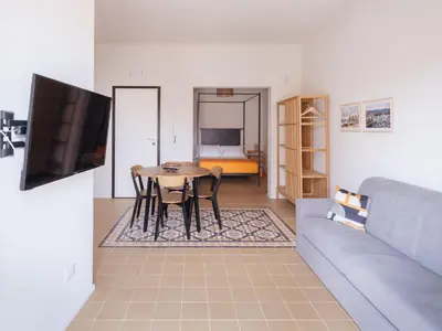 a living room with a table and a couch at Piricù Apartments in Castellammare del Golfo
