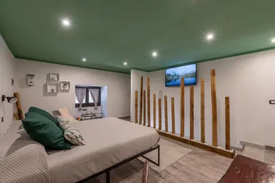 a room with a bed and a flat screen tv at Holiday Home GaribaldiOM Palermo Centro Storico! in Palermo