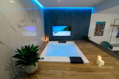 a bath tub with a tv in a room at B&B Maqueda - Room & Suite in Palermo