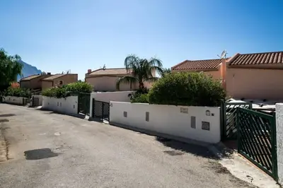 an empty street with a fence and some houses at Villa levante Macari in Macari