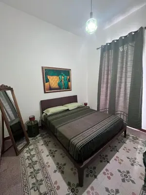 a bedroom with a bed in a room at Palazzo Orangea 2 piano in Bagheria