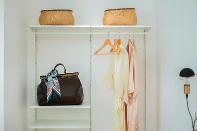 a closet with two racks of clothes and a purse at Palazzo Ventimiglia Lodge & Suites in Palermo