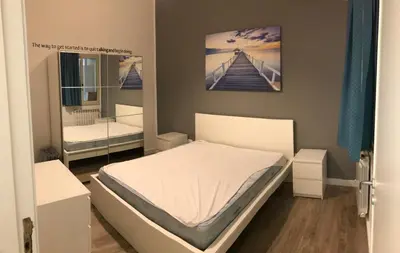 a small bedroom with a bed and a mirror at Appartamento Trilocale Mondello in Mondello