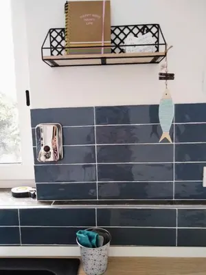a bathroom with navy blue tiles on the wall at Casina Blu in Palermo
