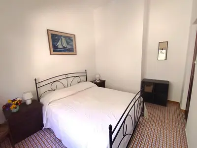 a bedroom with a bed with a white bedspread at La Casa Del Nonno in Monreale