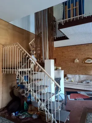a spiral staircase in a room with a bed at La Casa Del Nonno in Monreale