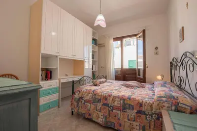 a large bedroom with a bed and a kitchen at A pochi passi dal mare in San Vito lo Capo