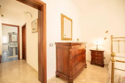 a room with a wooden dresser and a mirror at A pochi passi dal mare in San Vito lo Capo