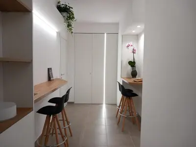 a kitchen with white walls and black stools at Blu in Blu Comfort rooms in Terrasini