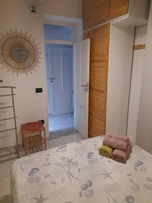 a bedroom with a bed and a mirror on the wall at Salsedine Apartment in Palermo