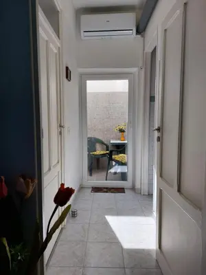 a hallway with a door leading to a dining room at Salsedine Apartment in Palermo