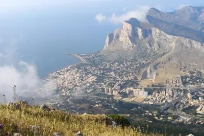 a view of a city with a mountain in the background at CASA 3T a Isola a 15 min dal centro di Palermo in Isola delle Femmine