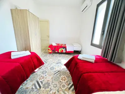 a bedroom with two beds and a toy car in it at Magaggiari Reef in Cinisi