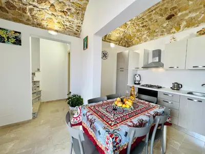 a kitchen with a table with fruit on it at Magaggiari Reef in Cinisi