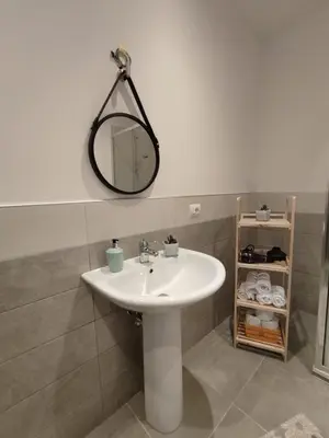 a bathroom with a sink and a mirror on the wall at Room Sixty One in Palermo