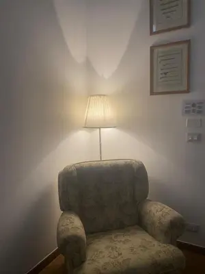 a chair and a lamp in a room at Casa di Vale in Palermo
