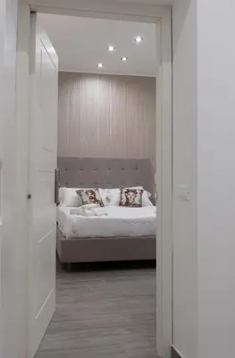 a bedroom with a bed with white sheets and pillows at Blanc Rooms in Palermo