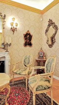 a living room with two chairs and a fireplace at La Baronessa in Palermo