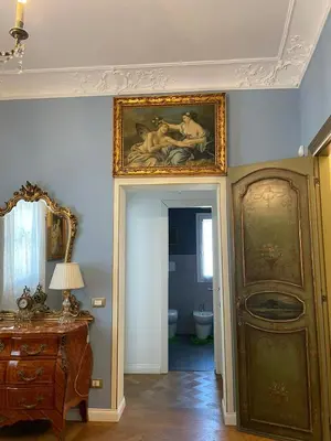 a room with a painting on the wall next to a door at La Baronessa in Palermo