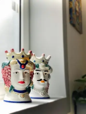 two vases sitting on top of a shelf at Attico Belvedere in Palermo