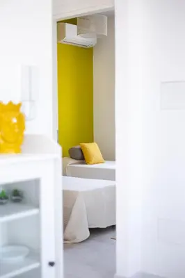 a bedroom with a bed with a yellow wall at Nice home in Carini