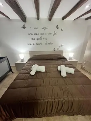 a bedroom with a large bed with two pillows at House del Corso in Palermo