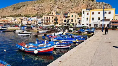 a group of boats are docked in a harbor at mansarda beach Mondello in Palermo