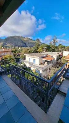 a balcony with a view of a city at mansarda beach Mondello in Palermo