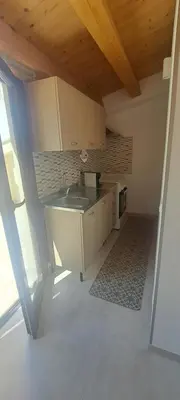 a kitchen with a sink and a microwave at Mamma Rosa Casa Vacanze in Castellammare del Golfo