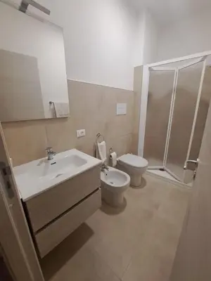 a bathroom with a sink and a toilet and a shower at Mamma Rosa Casa Vacanze in Castellammare del Golfo
