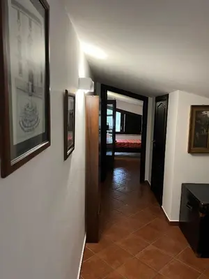 a hallway leading to a room with a bedroom at Via delle Rose in Torretta