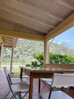 a table and chairs on a porch with a view at Via delle Rose in Torretta