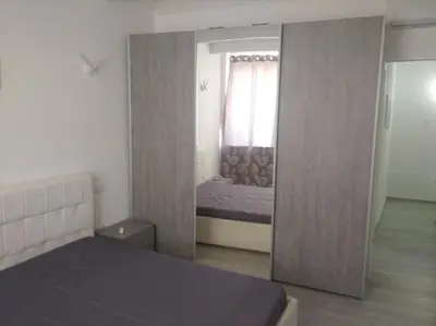 a bedroom with a door leading to a bed and a mirror at Casa vacanze Venere in Balestrate