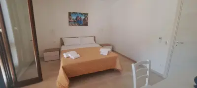 a small room with a bed and a table at Mamma Rosa Casa Vacanze in Castellammare del Golfo