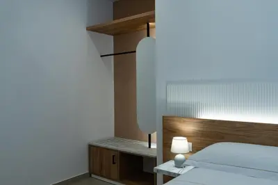 a bedroom with a bed and a table with a lamp at B&B Alba in Terrasini