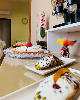 two slices of pizza on a plate next to a bottle at Crispi 120 Rooms New Opening in Palermo