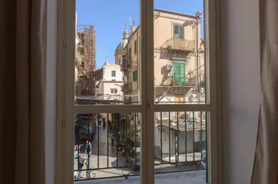 a view from a window of a city street at La Casa del Mercado in Palermo