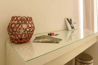 a glass counter with a vase and a book on it at La Casa del Mercado in Palermo
