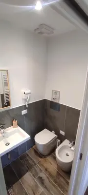 a bathroom with a toilet and a sink at Green Suite Palermo in Palermo