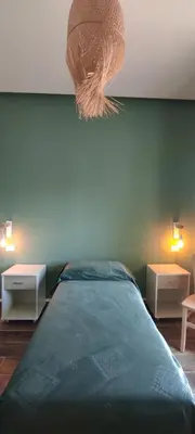 a bedroom with a bed and two tables and a hat at Green Suite Palermo in Palermo