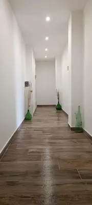 an empty room with white walls and wood floors at Green Suite Palermo in Palermo