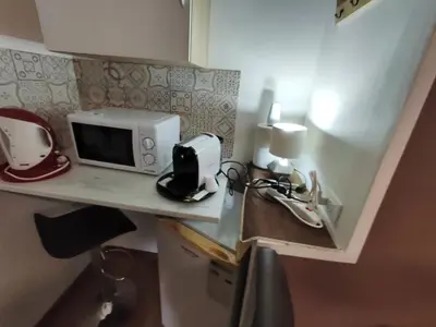 a small kitchen with a microwave on a counter at Medea rooms palermo centro in Palermo