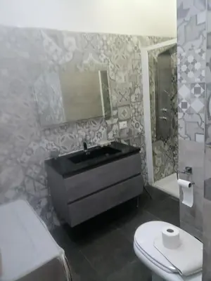 a bathroom with a black sink and a toilet at Medea rooms palermo centro in Palermo