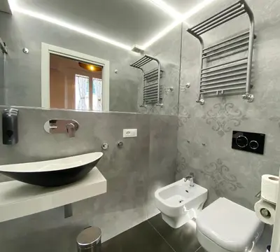 a bathroom with a sink and a toilet and a mirror at Casa Granatelli in Palermo